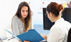 A woman meets with her doctor to review the results of a recent test